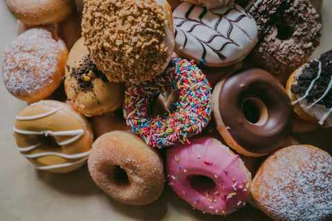 an assortment of colorful donuts, high in sugar and unhealthy, but delicious