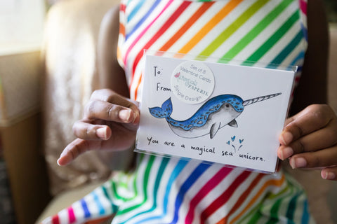 Girl holding narwhal Valentine's Day Card