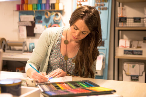 Sarah Collins illustrating in her Whimsicals paperie studio