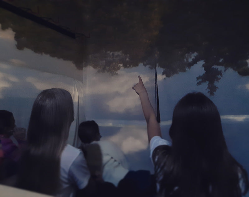 School children are amazed of the Camera Obscura effect they see on the wall