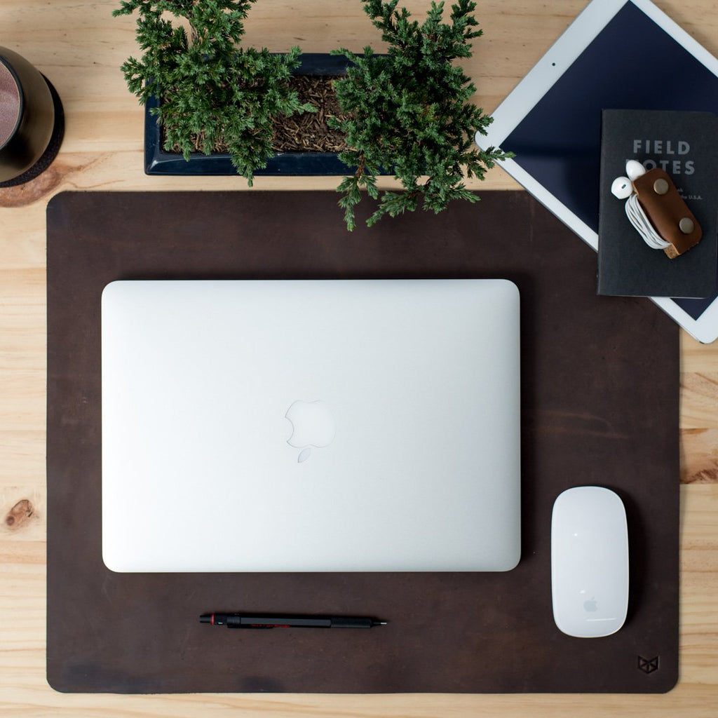 brown leather desk pad with laptop