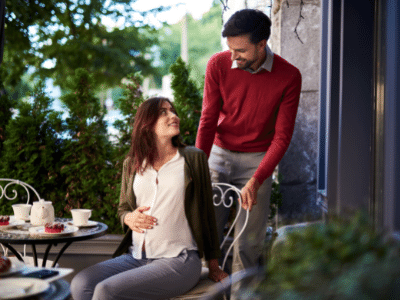 man pulling out chair for woman