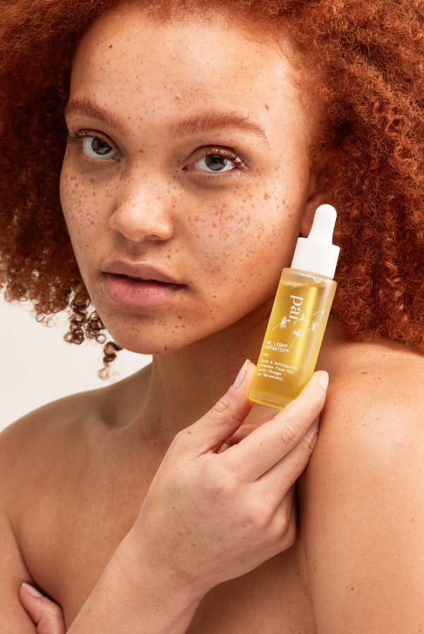  Woman using Pai Skincare The Light Fantastic face oil