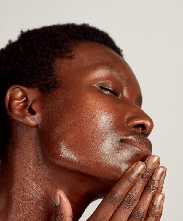 black woman touching cleansed face