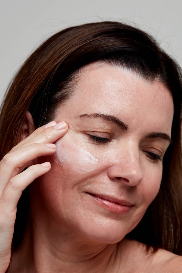 Woman using moisturiser