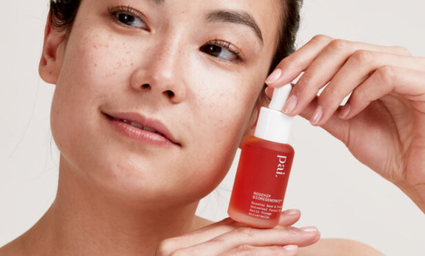 woman holding rosehip oil bottle