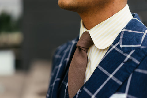Blue blazer with white shirt and brown tie