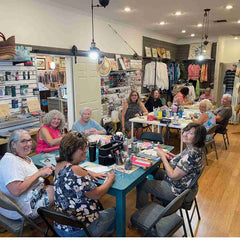 artists working around the table together at Island Cove