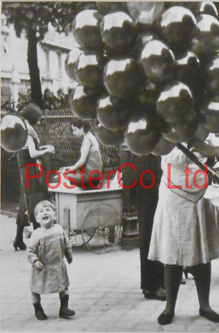 Childhood, A Yound child looks in wonder at a Balloon Sellers wears