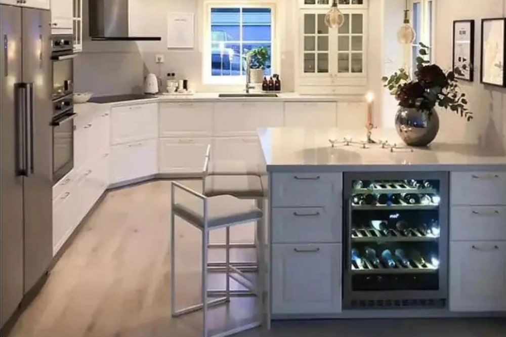 A smallish modern kitchen with a mQuvée wine cooler built-in to the kitchen breakfast bar.
