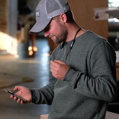 Man using ISOtunes SafeMax™ volume limiter to conserve his hearing when listening to music 