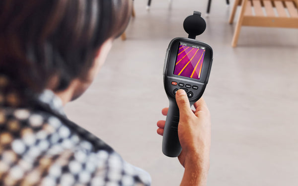 man holding perfectprime thermal camera