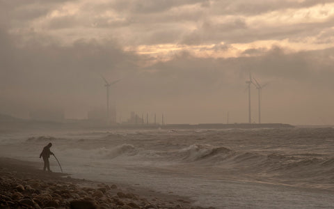 Man in wasteland with pollution in background