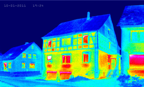 Thermal images of three houses showing heat inside the windows of the houses