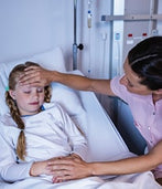 A child is sick and a nurse is taking care of her