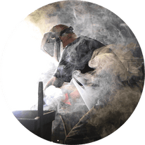 man welding in smoke