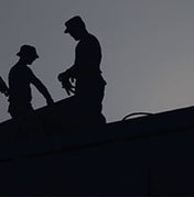 2 people stands on roof