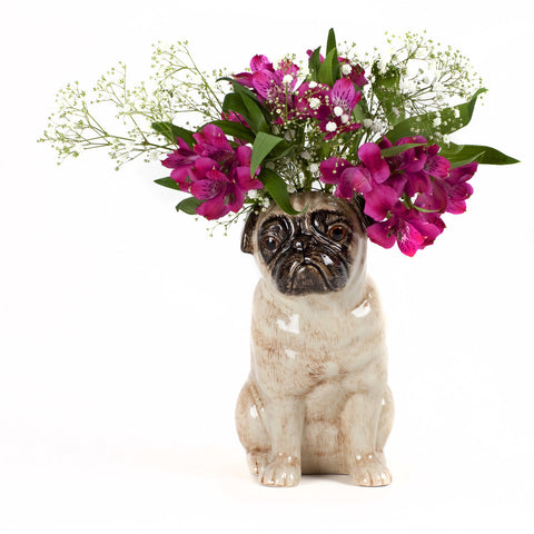a vase shaped like a pug with pink and white flowers