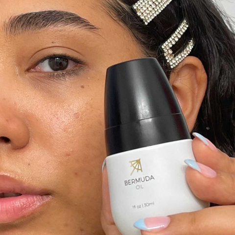 Female Using Bermuda Oil To Help Treat Dark Spots Naturally 