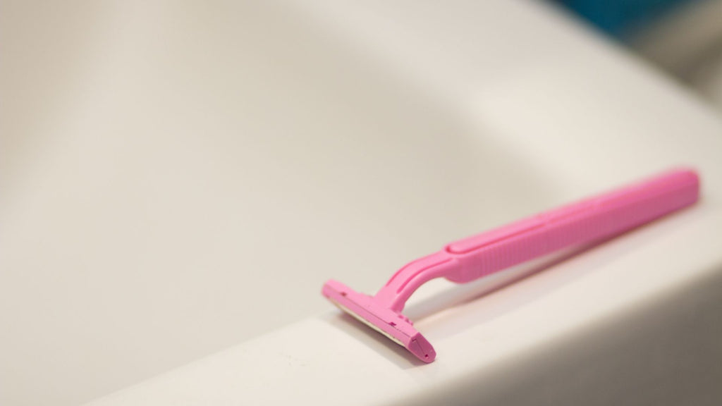 A sharp disposable razor on a sink counter