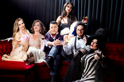 Quirky vintage friends on red velvet lounge drinking cocktails. The cast of the of the Night Cap are the best burlesque comedy cabaret vaudeville entertainers in Sydney. Photo by Tony Palliser features Catherine Bolitho, Nicoljayne Campbell, Daniele Gorski, Daniele Clements, Jared Jekyll and Eva Devore. 