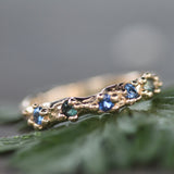 blue & green sapphires set in a mermaid treasure band in 14k yellow gold 