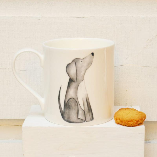 Black labrador on white ceramic mug