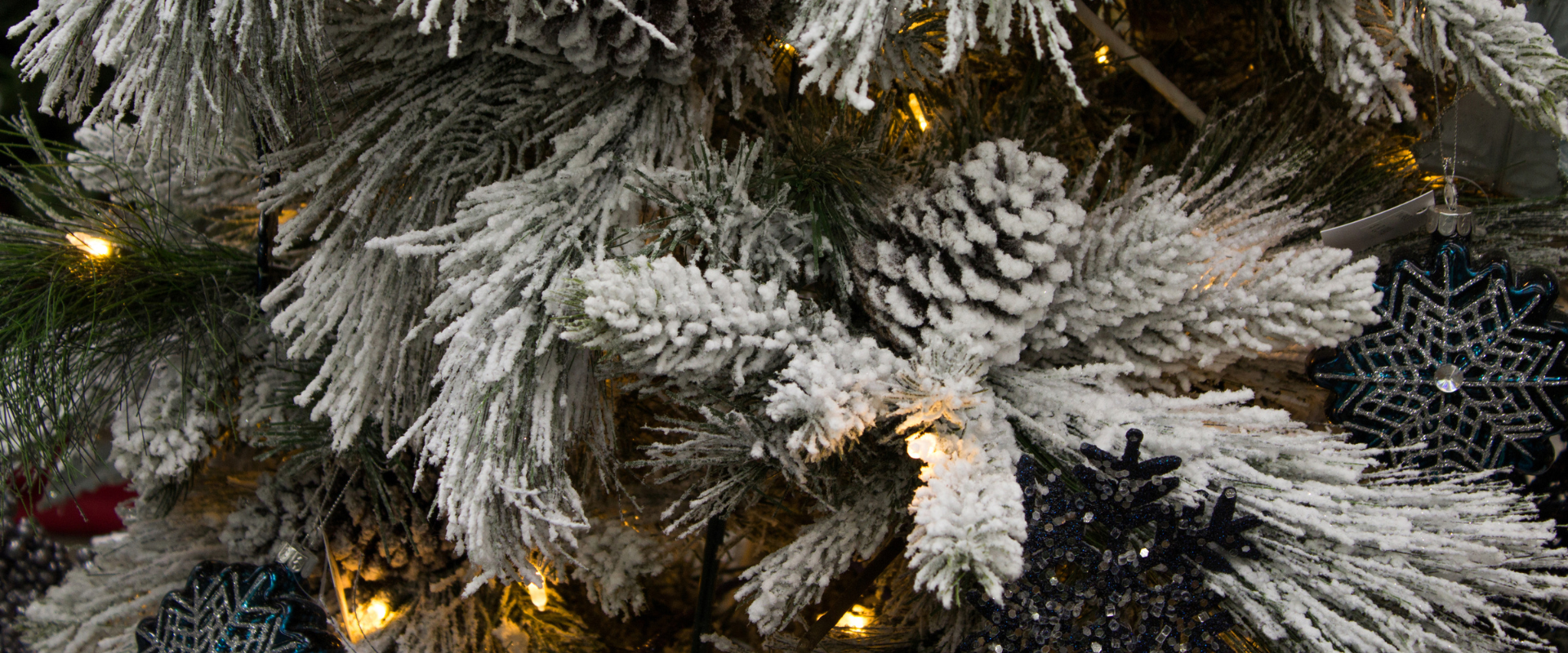 An artificial Christmas tree with decorative snow and lights