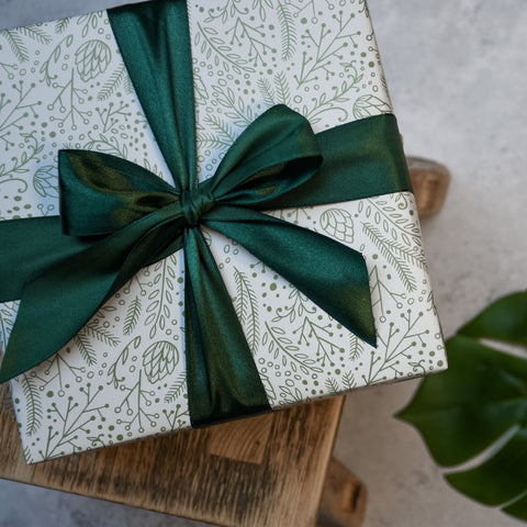 Wrapped Christmas Gift with Green and white wrapping paper and a dark green bow