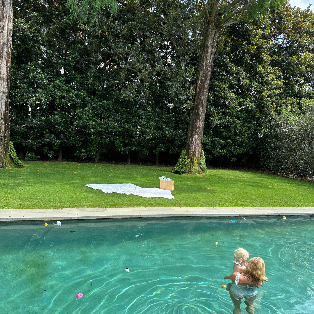 mom and baby in pool wearing minnow