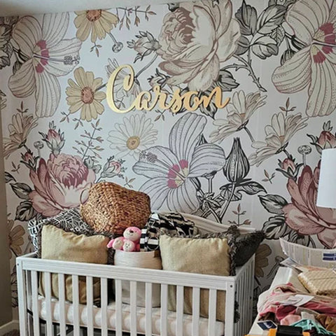 gold nursery name sign on floral wallpaper wall girl nursery