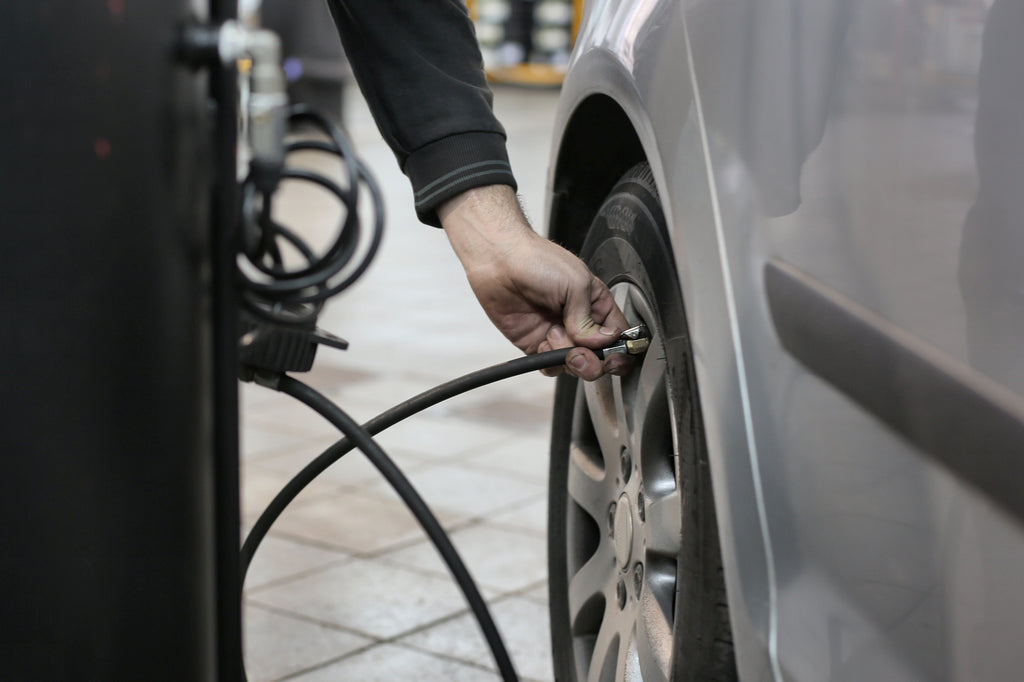 Man Checking Tire Air Pressure