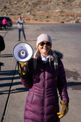 Dig Paddlesports' Tamra gets mega-cheerful on the Polar Plunge megaphone.