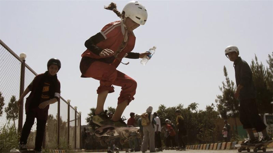 An Afghan girl jumps on her skateboard in Kabul on June 21, 2012; hundreds of Afghan boys and girls celebrated World Skateboarding Day in the national capital [File: Ahmad Jamshid/AP]