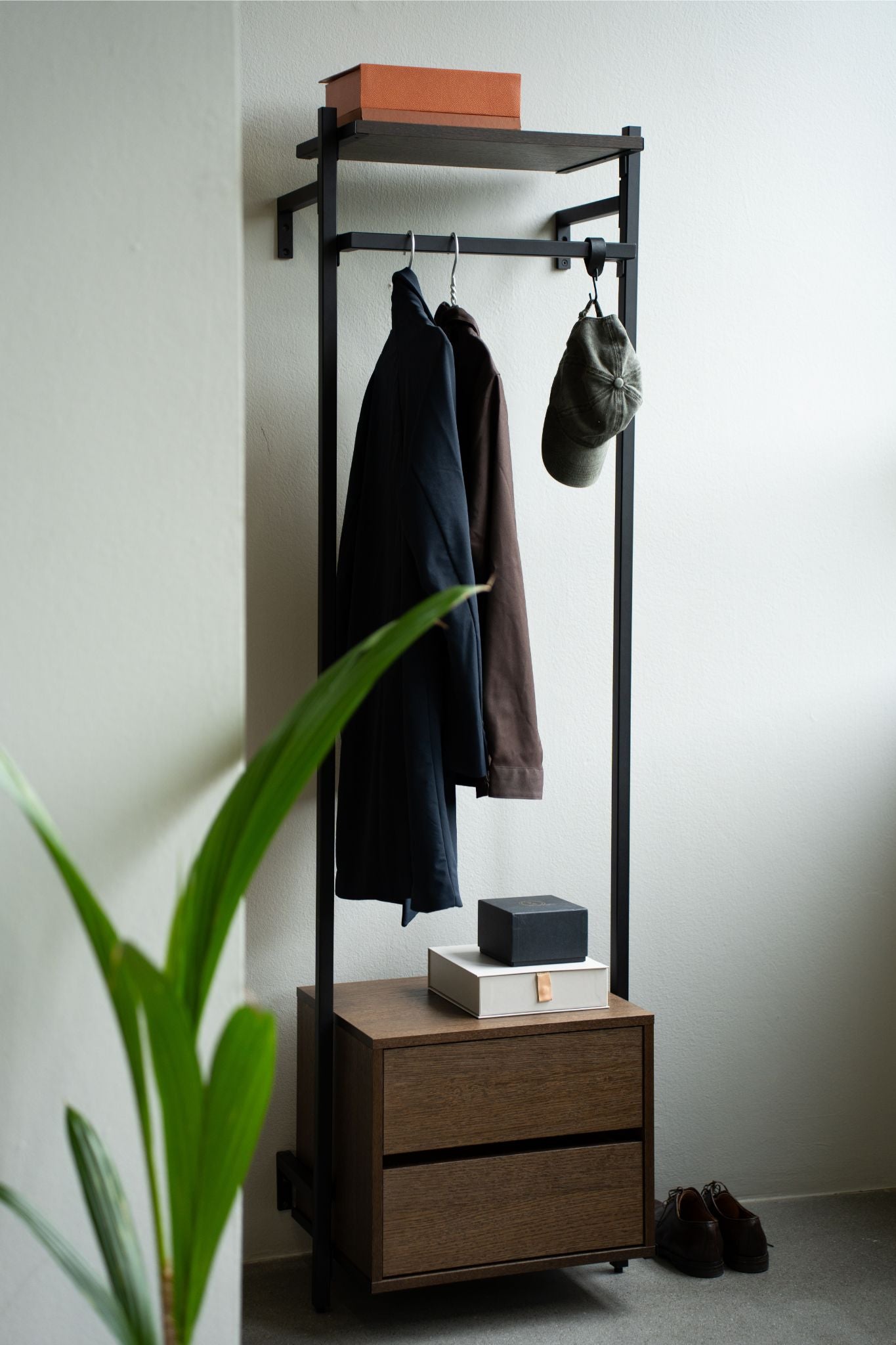 Narrow open wardrobe with dark pipes and smoked oak dresser