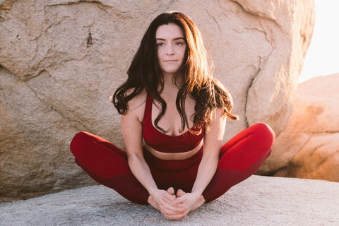 athletic woman doing butterfly stretch