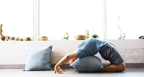 man doing yoga session indoors