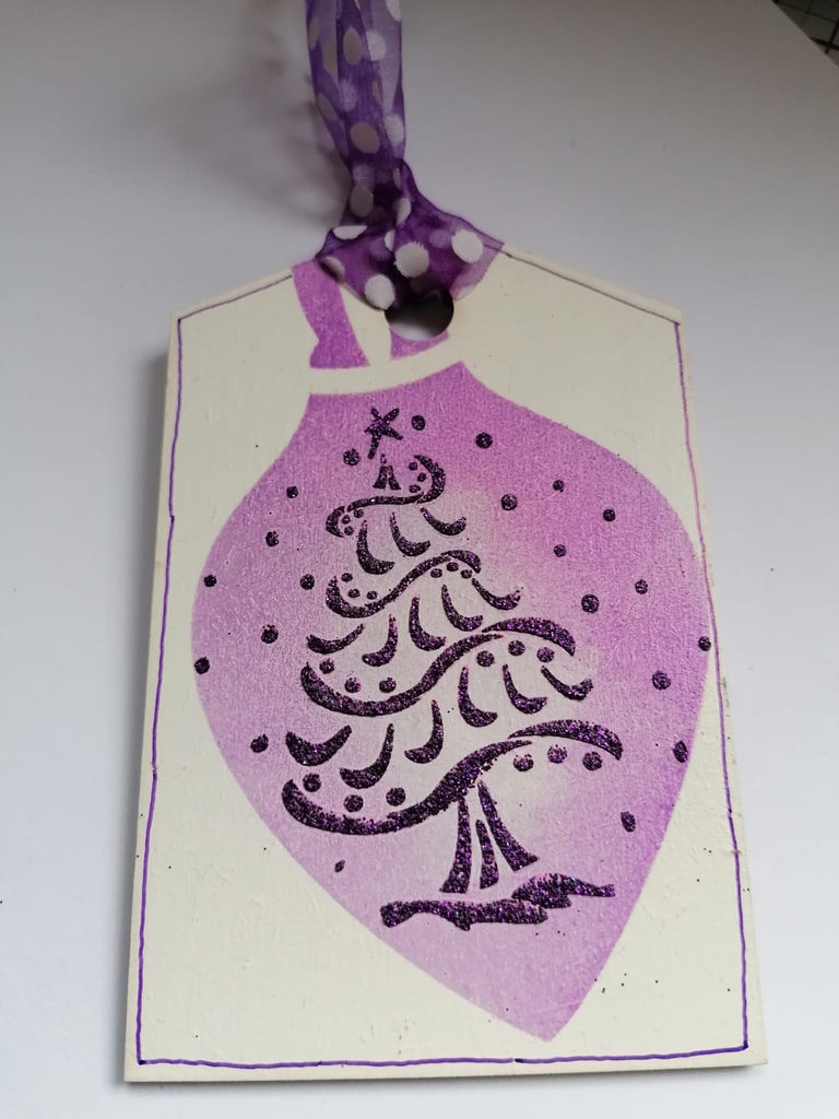 Glitter paste applied using stencil on to MDF Christmas tag 