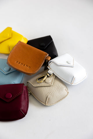 Carolyn Air Pods case in whisky, black, smoke, white, raspberry, yellow leather.