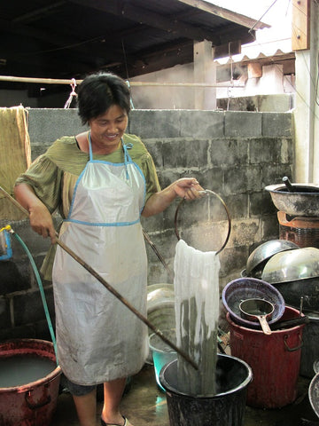 Thai artisan dying a mud scarf