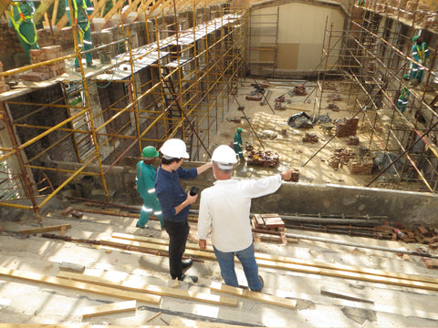 two men at construction site wearing hard hats