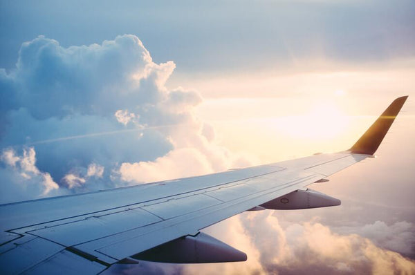 Photo of an airplane wing in the sky