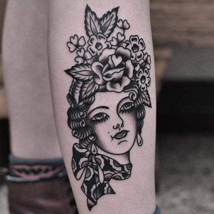 Flower head woman tattoo on the shoulder healed
