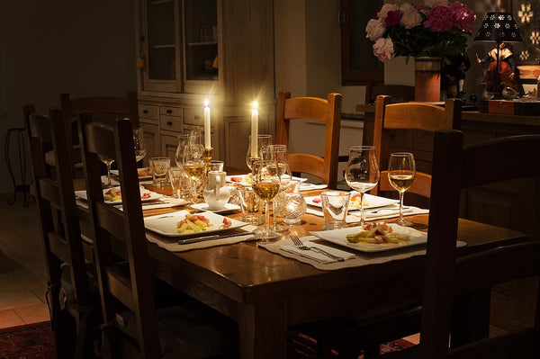 table that has been set with the only light coming from candles 