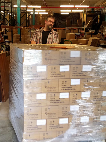 Patrick slingin pallets in the warehouse.