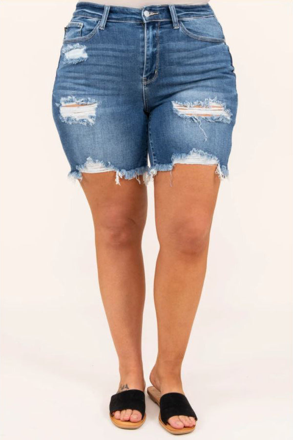 a close up of a full figured woman sporting a pair of wont change my hearts shorts medium wash