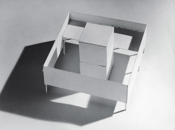 Monochrome image of a white box on a white background with shadows..