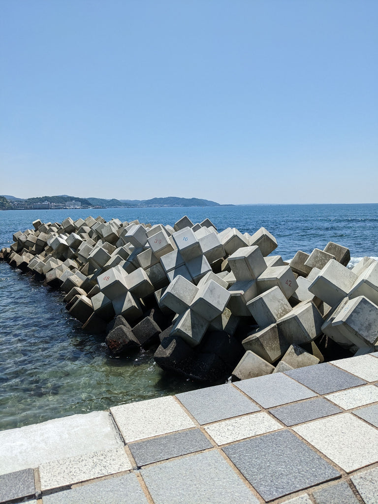 Piles of large cement cubes sitting in water
