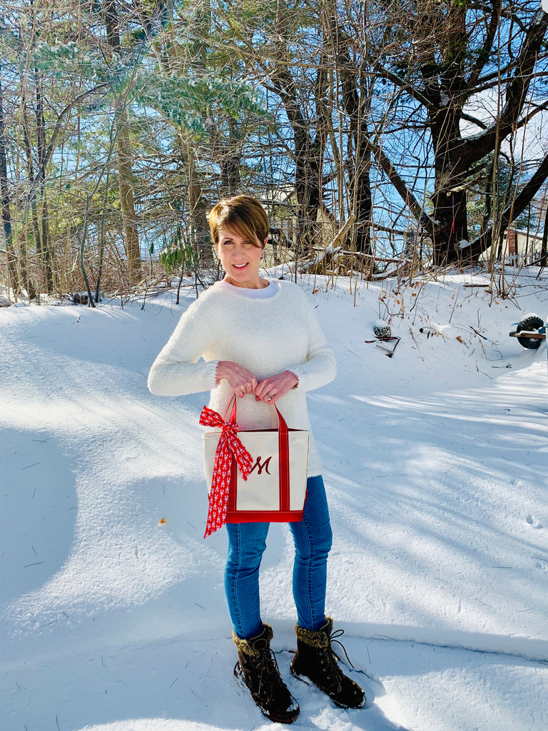Laura holding L.L. Bean Boat and Tote bag with The Maine Square lobster print retro ribbon tied on it