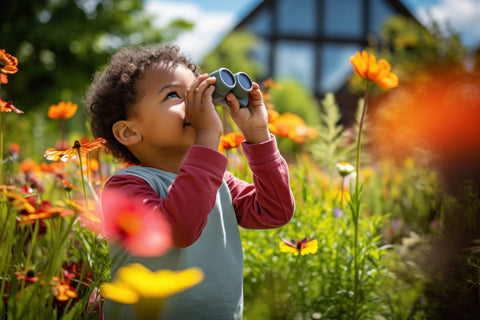 toddler birdwatching with binoculars